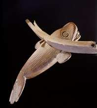 A wood carving of a whale