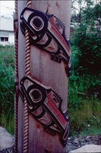 Detail of totem pole showing carving of two salmon