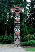 Totem pole with hawk or sunbird false box on the top