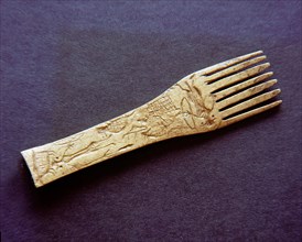Comb incised with a design of an archer standing over a prostrate man and a variety of animals