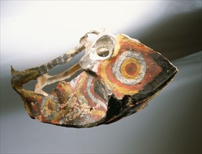 Asmat painted cassowary bone representing the dragon like head of the mythological giant cassowary
