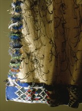 A chiefs korowai or feather cloak with a multi coloured feather border