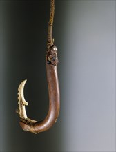 A barbed composite matau fish hook, the shank made by training a growing branch into shape