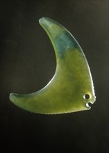 An amulet in the form of a green stone semi translucent fish