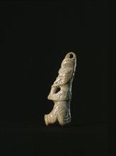Tiny human bone tiki pendant depicting an ancestor of the Ngati Apa or Ngai Tumatokokiri tribes, both of which were conquered early in the nineteenth century by tribes from Taranaki