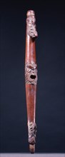 Putorino, or flute trumpet carved with three aggressive faces