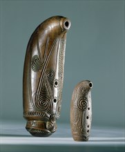 Nguru, open tube flutes, with three finger holes are blown across the wide end