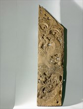 Carved in unusually low relief, this end post, epa, from a Taranaki storehouse depicts the interaction of ancestral figures and manaia, profile figures representing the supernatural world