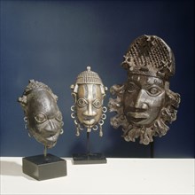 Three ornamental hip masks which formed part of the regalia of Benin chiefs