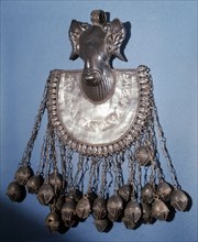 A brass pectoral ornament, part of a chiefs regalia, depicting a rams head