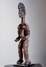 Female shrine figure, part of a family of such figures kept in a village shrine, illustrating the continuity of social roles in the world of the living and that of the spirits