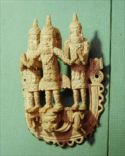 An ivory hip pendant depicting an Oba (Benin king) and two attendants