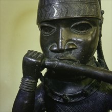 A figure of a hornblower or trumpeter such as would have been part of the retinue of important chiefs and warriors at the Benin court