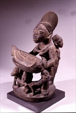 An offering bowl in the form of a mother and child with supporting figures