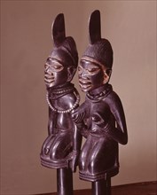 Dance staffs depicting male and female devotees of Eshu, identifiable by the projection from their heads
