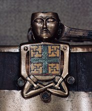 A figure of Hiberno Saxon origin on the handle of a bucket with swastika symbols of Thor