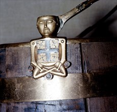 A figure of Hiberno Saxon origin on the handle of a bucket with swastika symbols of Thor