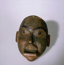 Wooden mask carved in the form of a mans face, with moustache and copper labret