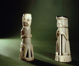 Two carved ivory figures depicting Europeans