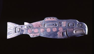A wooden totemic carving in the form of a salmon