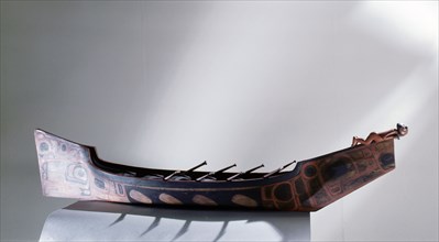 Painted war canoe with figurehead