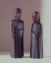 Carved figures of a pair of missionaries