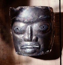 Copper mask of a human face