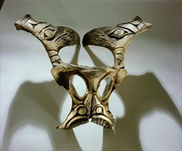 An animal vertebra carved with zoomorphic designs