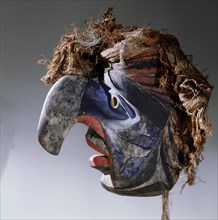Mask with a human face and eagle beak representing an ancestor that that came to earth as an eagle