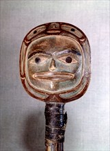 Wooden rattle in the form of a two sided human head