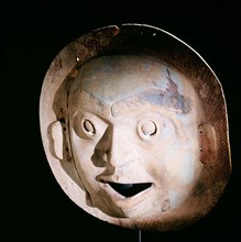 A mask carved to represent the moon