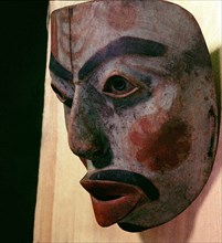 Wooden mask with human face