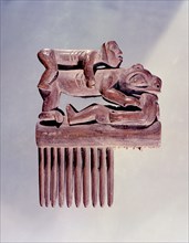 Shamans comb with carvings of a bear and two humans