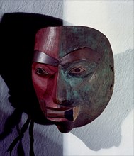 Mask in the form of a womans face with a lip plug