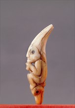 Shamans charm, cut from canine teeth in the form of a foetal human