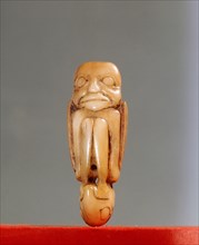 Shamans charm, cut from canine teeth in the form of a foetal human