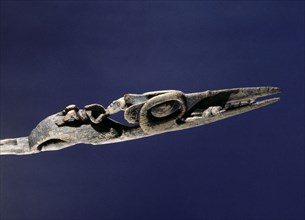 Wand carved to represent a crane with the witch spirit on the beak