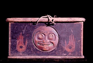 A shamans storage chest carved with a face representing the moon