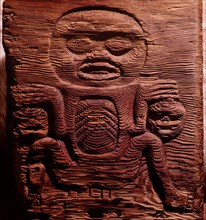 A cedar box carved in relief with a shaman displaying human heads