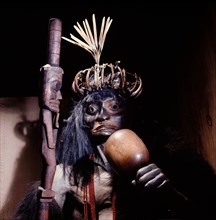 The ritual robes and equipment of a shaman displayed on a model
