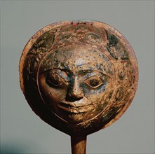 Shamans rattle in the form of a face with a border carved in low relief