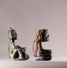 Pair of stone human figure bowls, thought to have been used by Salish shamans in purification rites as part of ceremonies marking the onset of female puberty