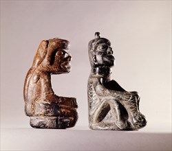Pair of stone human figure bowls, thought to have been used by Salish shamans in purification rites as part of ceremonies marking the onset of female puberty