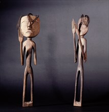 A pair of figures representing shamans with raised hands
