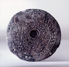 Spindle whorl, used by the Coast Salish during spinning to prevent the wool slipping from the spindle