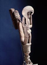 Halibut fish hook carved with the image of a man holding a float over his head