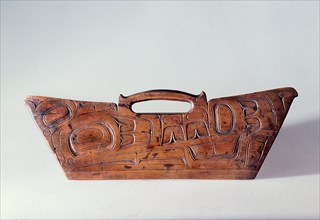 Bark shredder made of wood and carved in relief