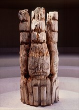 The top section of a Haida house frontal pole depicting three watchmen