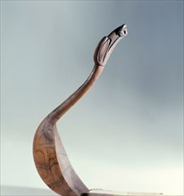 Spoon carved with a bird with a frog in its beak