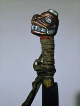 The handle of an iron bladed knife carved from the horn of a bighorn sheep and inlaid with iridescent abalone shell